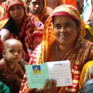 woman displaying her lending group membership card